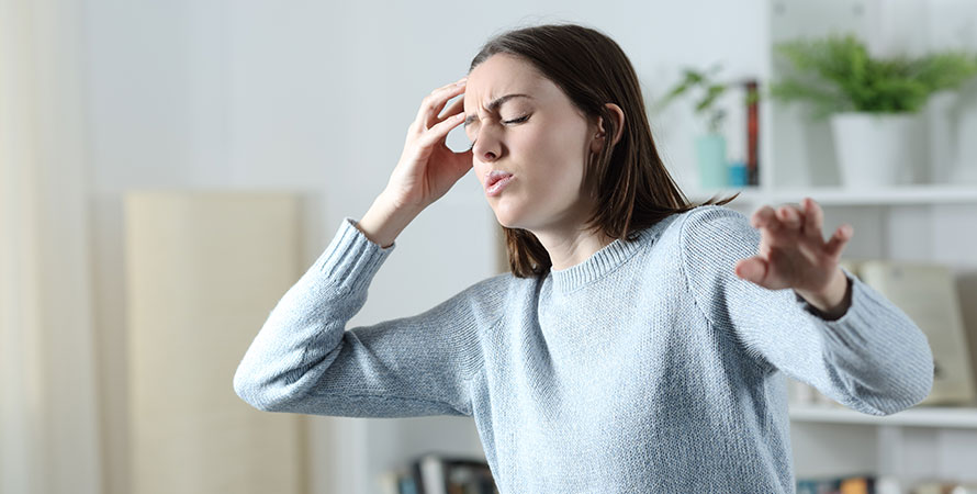 dizzy-woman-suffering-vertigo-attack-standing