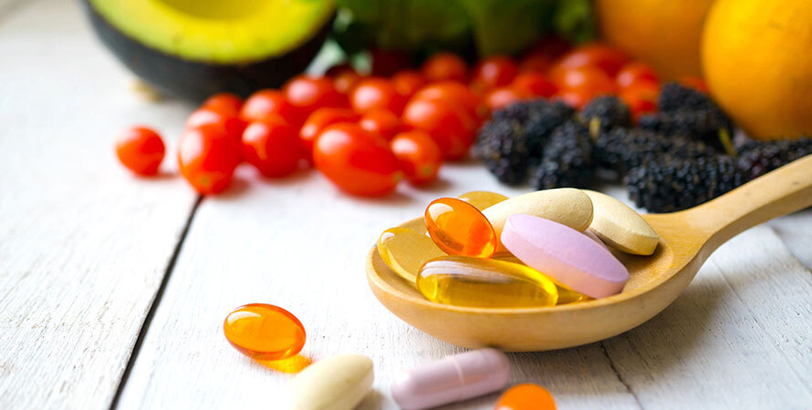 a spoonful of pills and fruits