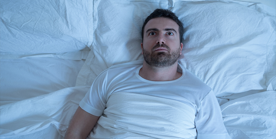 stressed-man-trying-sleep-his-bed-