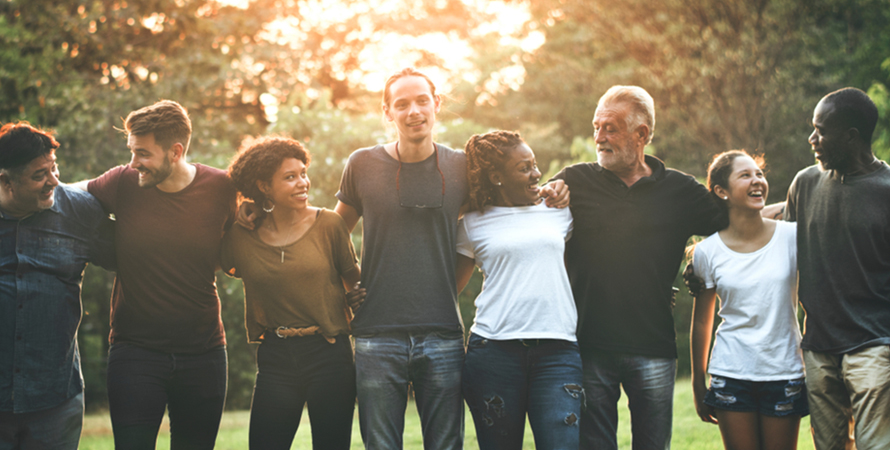 Cheerful diverse people huddling park